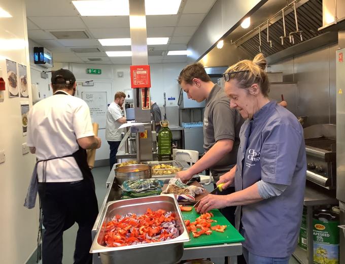 Two students from Ganton School doing food preparation and cutting vegetables.