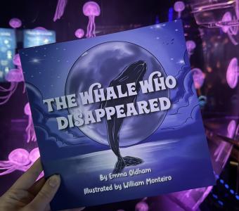 The Whale Who Disappeared book in front of the Moon jellyfish exhibit